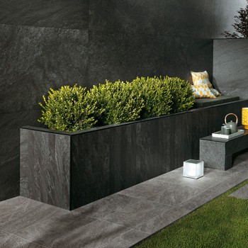 HDG Coke Porcelain Tile Set on Grass and Used in Planter Design and Wall Cladding
