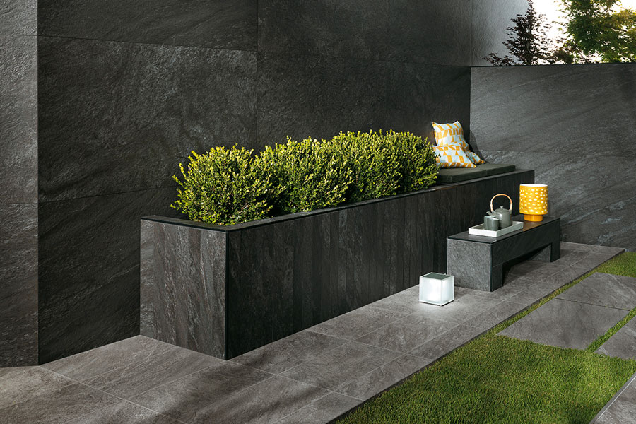 HDG Coke Porcelain Tile Set on Grass and Used in Planter Design and Wall Cladding