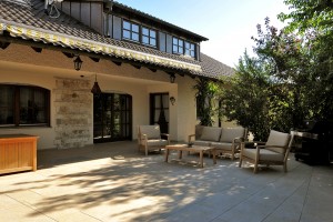 Outdoor Living Area Designed with HDG Trust Gold Porcelain Pavers to Match Design of House