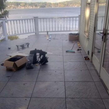 Sierra Graphite porcelain pavers installed on slope-correcting adjustable Buzon pedestals for a level deck.