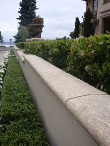 image of Curved and Finished Coping Stone Atop Natural Stone Wall in Landscape Design - HDG Building Materials
