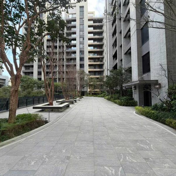 Modern condominium courtyard with landscaped pathways and HDG Colo-Grigi Drive-Over 3cm porcelain pavers designed for vehicular and parking lot use.
