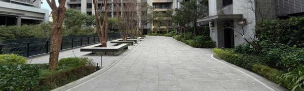 Modern outdoor courtyard featuring HDG Colo-Grigi porcelain pavers with a dark grey fleuri-cut limestone finish.
