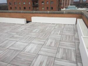 Acacia Porcelain Pavers on Rooftop Deck with Parapet and Planters Shown