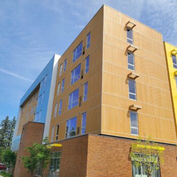 Resysta Cladding Vertical Installation on ROCK Apartments - HDG Building Materials
