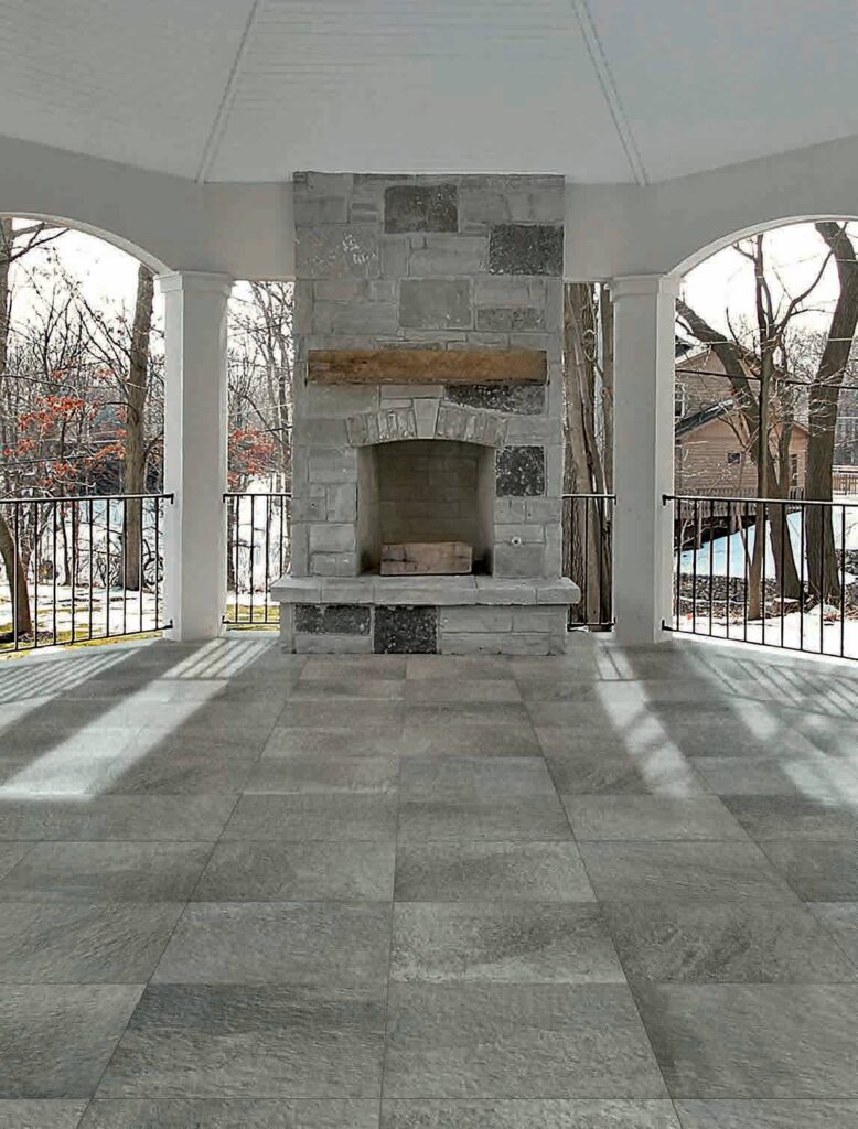 Natural Stone Fireplace with Porcelain Pavers to Match