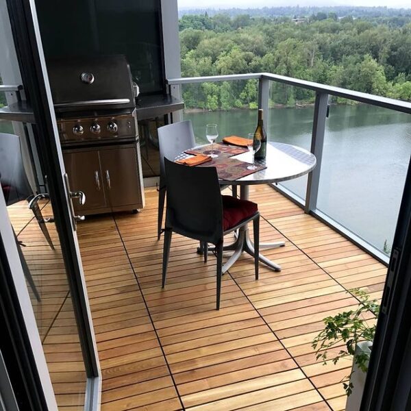 Balcony Uses Black Locust Deck Tiles Over Buzon Pedestals to Create Outdoor Living Space