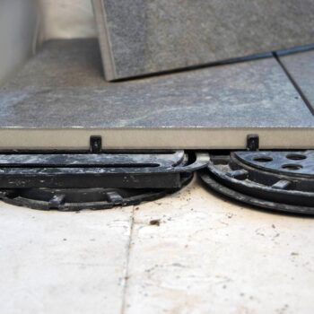 Spacer Tabs and Shims and Buzon U-EDGE Shown on Buzon Pedestals and Porcelain Pavers