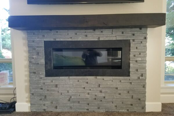 Black Limestone Fireplace with Articulated Face