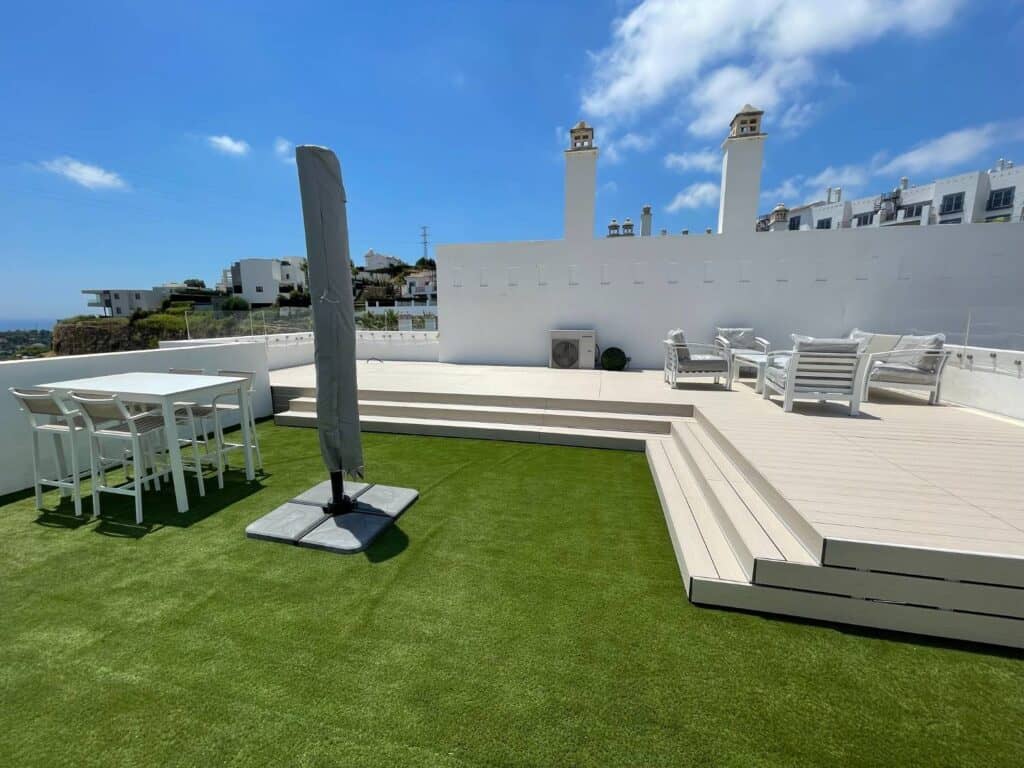 Low maintenance composite decking installed over an aluminum joist and pedestal system on a commercial rooftop terrace.