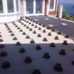 Small Concrete Pavers Over Minimesh Grating On Top of Buzon Pedestals
