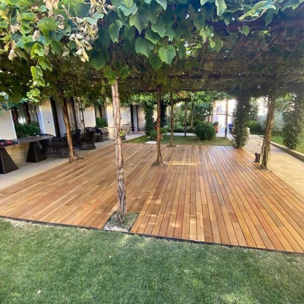 Buzon Pedestals Support Wood Decking in Outdoor Dining Area Under the Trees