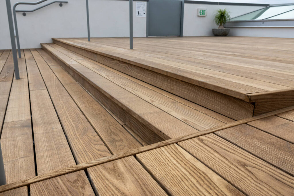 Beautiful Thermo Ash Decking and Stair Detail on Rooftop Deck Made with Buzon Pedestals