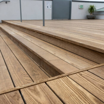 Beautiful Thermo Ash Decking and Stair Detail on Rooftop Deck Made with Buzon Pedestals