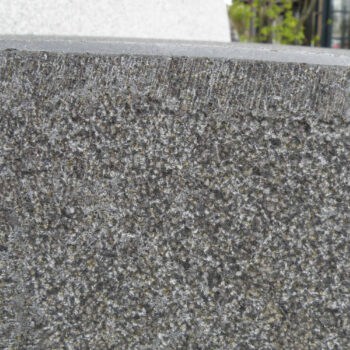 Bigio Grey Granite with an Adze Finished Edge and Bush-Hammered Body Next to Cristallo White Granite