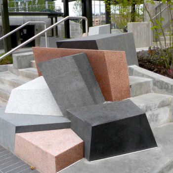 Tumbled Granite and Basalt Blocks in Multiple Colors and Finishes Held in Place with Structural Concrete.