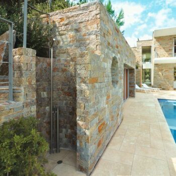 Cream Travertine Finish Porcelain Pavers next to Natural Stone in Pool Surround and Outdoor Shower