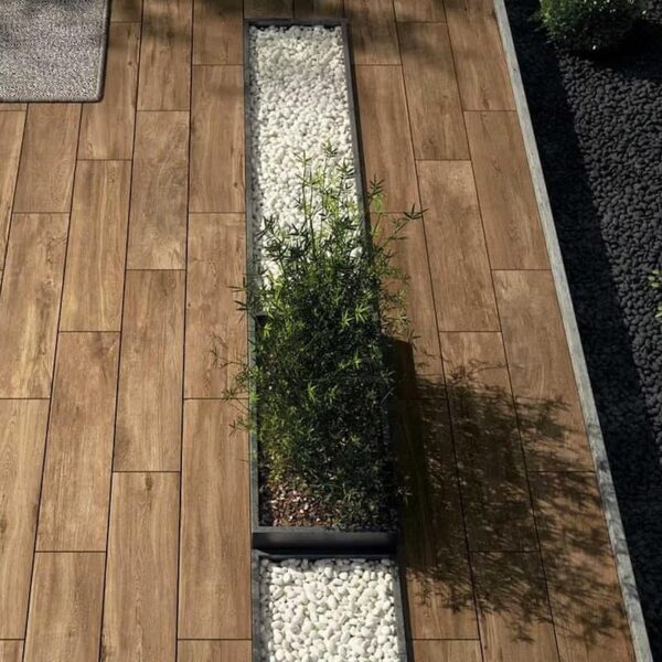 Completed outdoor terrace with 12×48-inch Espiro Indie Brown wood-look porcelain paver planks.