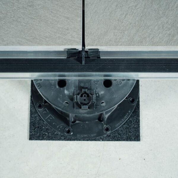 Spacer tabs keeping porcelain pavers aligned over Easy Rail aluminum joist system.