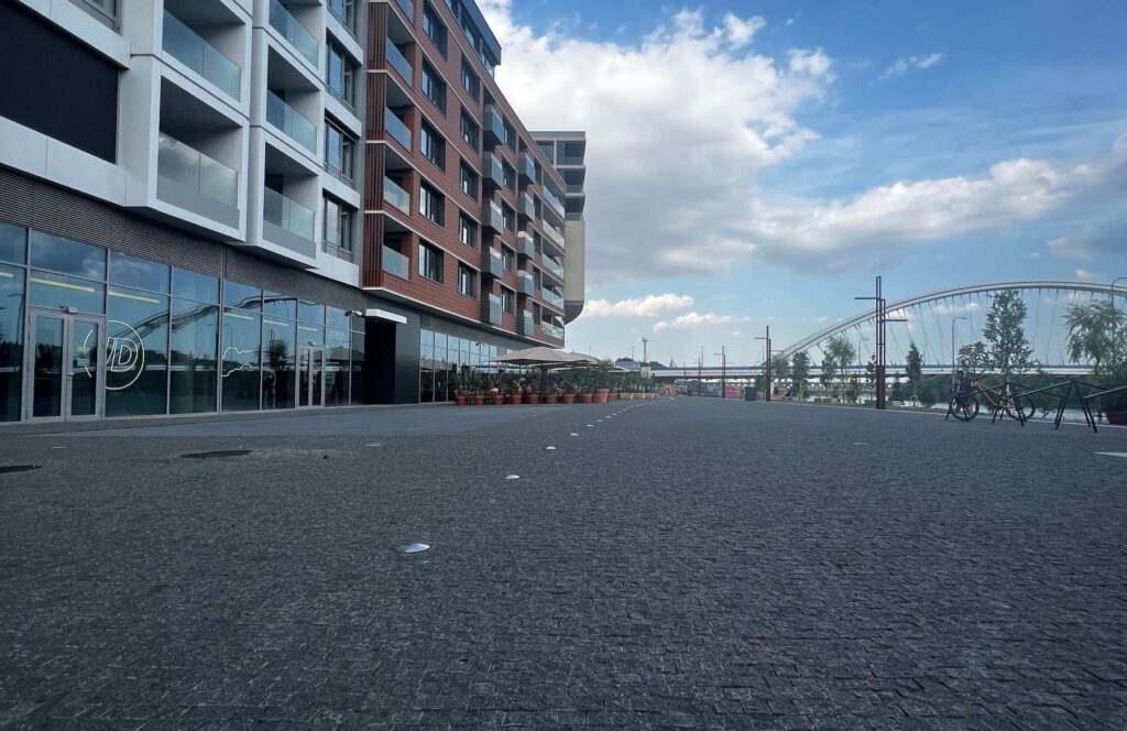 Pedestrian boulevard paved with small-format granite cobblestones. HDG Black Sea Blue Granite in urban setting.