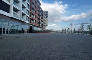 Pedestrian boulevard paved with small-format granite cobblestones. HDG Black Sea Blue Granite in urban setting.