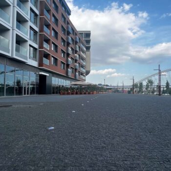 Pedestrian boulevard paved with small-format granite cobblestones. HDG Black Sea Blue Granite in urban setting.
