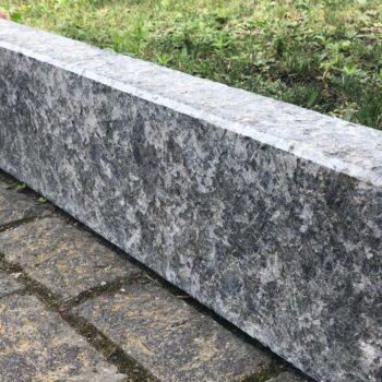 Tall Black Sea Blue Granite curbstone installed alongside brick-shaped granite pavers.