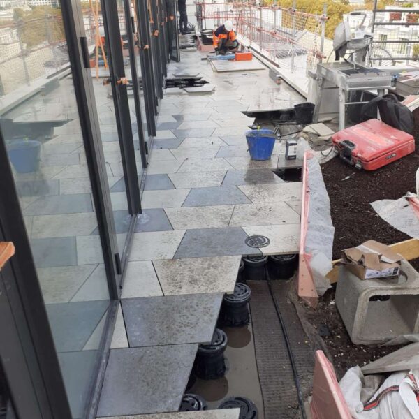 Rooftop Terrace Under Contruction with Buzon Pedestals and Trapezoid Porcelain Pavers