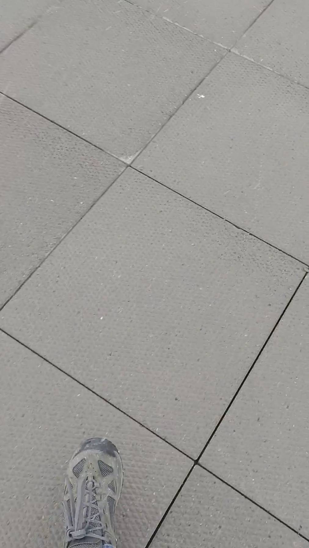 Spaces between porcelain pavers on elevated deck allows water to pass.