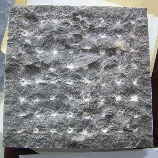 Close-up of Caviar Blue limestone with pineapple stone finish, highlighting the raised diamond-pattern texture.