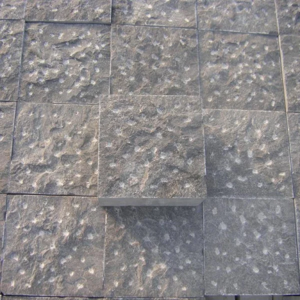 Cobblestones made from Caviar Blue limestone with pineapple stone finish, showing a textured surface designed for durability and grip.