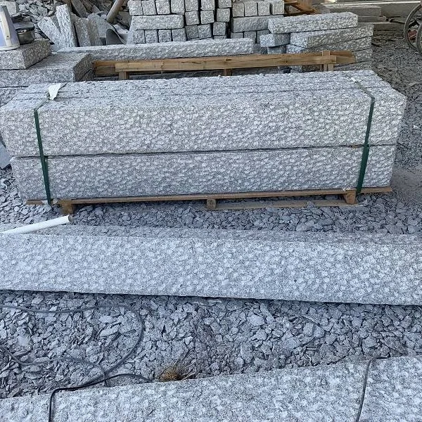 Curbstones in Caviar Blue limestone with sawn face and pineapple stone finish, featuring a structured yet textured surface.