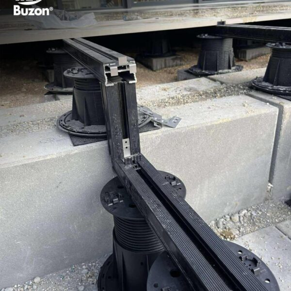 Buzon pedestal and rail system installed over uneven surface with slope correction and U-Pads