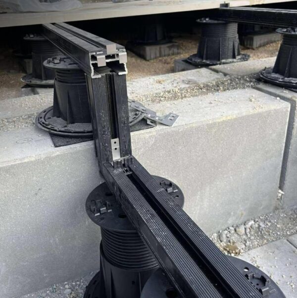 Alt text: Buzon pedestal and rail system installed over uneven surface with slope correction and U-Pads