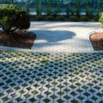Public streetscape with concrete sidewalks, grassy permeable pavers, and symmetrical tree-lined planting areas.