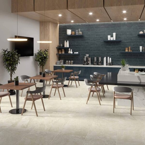 Ardesia White 24x24-inch porcelain pavers create an elevated outdoor hospitality lounge with seating and a coffee station.