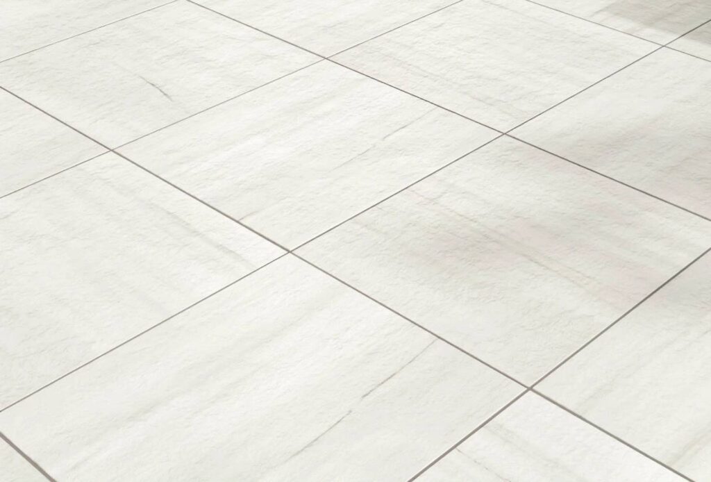 Marmo White porcelain pavers arranged in a directional cross-pattern on a pool deck, highlighting the marble-inspired grain and veining.
